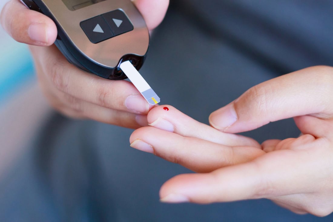 Measuring blood glucose with a glucometer for type 2 diabetes management.