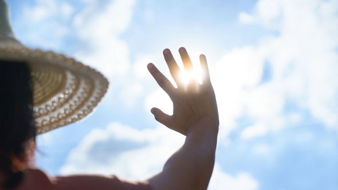 Sunshine and hand covering the sun during heatwave and heat plan in the Netherlands.